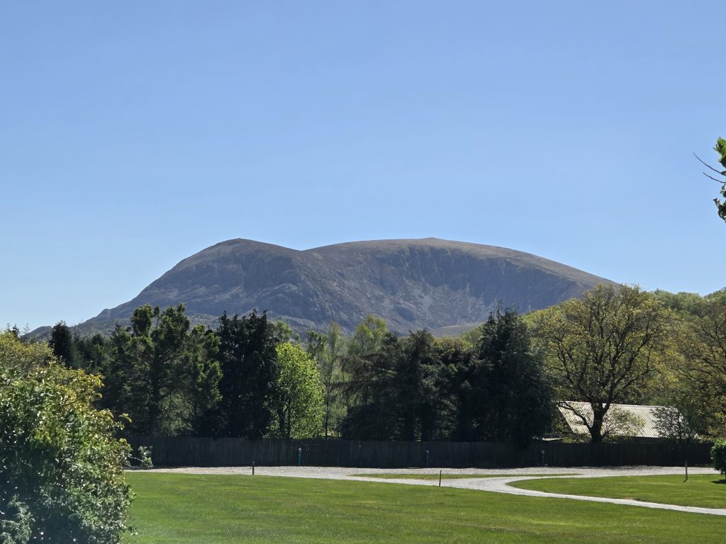 Image of Mynydd Mawr (Elephant Mountain) in Eryri (Snowdonia) North Wales - It is the inspiration for the children's books 'Wyddfa Whirlwinds and the Elephant Mountain' ‘Wyddfa Whirlwinds a Mynydd Eliffant’ by Amelia Chaffinch. Viewed from Tafarn Snowdonia Parc carpark, Waunfawr, Caernarfon, Gwynedd, LL55 4AQ, UK (Next to the Ffestiniog Railway Waunfawr Station) 